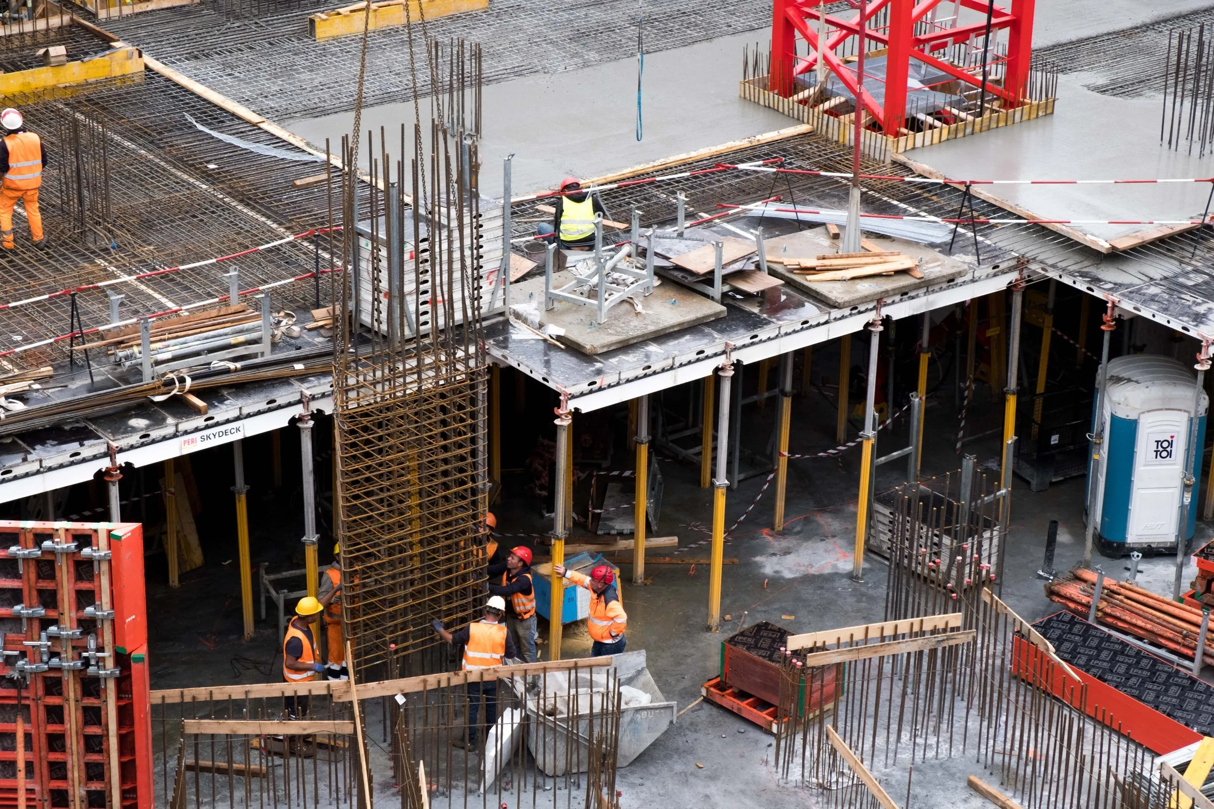 Commercial building under construction with steel frame and site crew