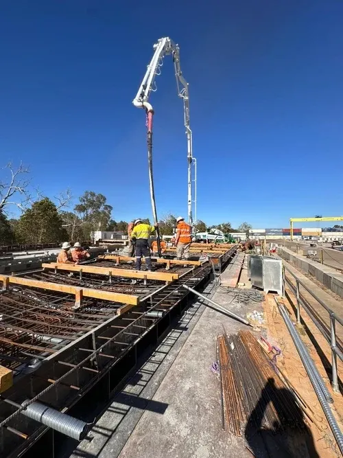 Concrete pump boom positioned over a reinforced slab pour