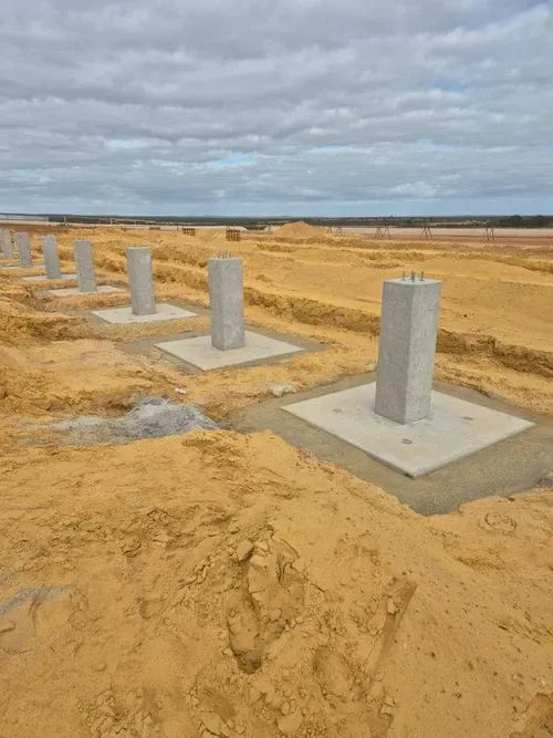 Concrete footings with starter columns on a cleared civil site