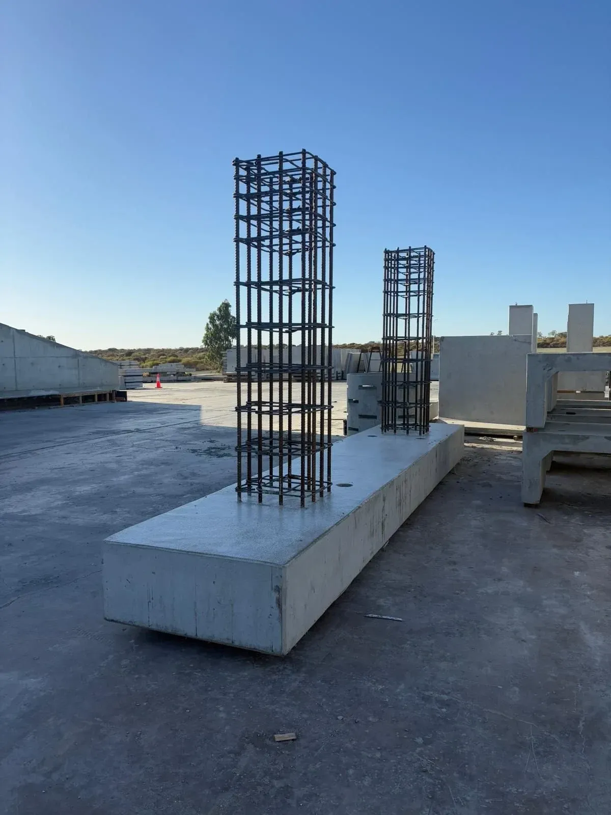Precast beam with column reinforcement cages ready for casting