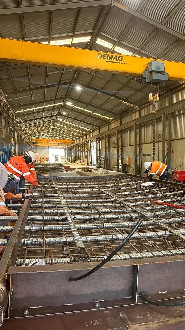 Inside a precast concrete production facility with gantry crane